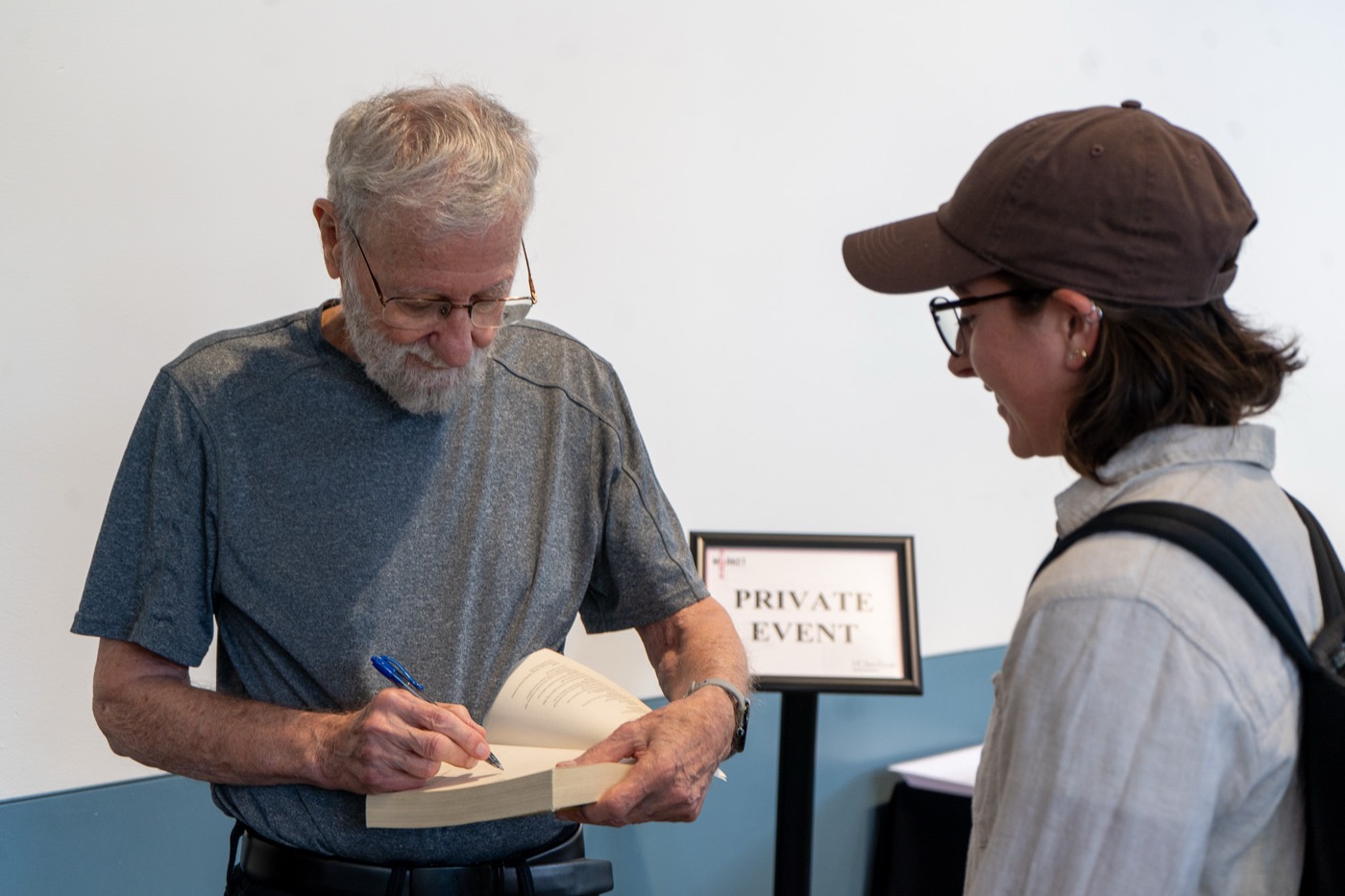 Don Norman signing a book for an attendee