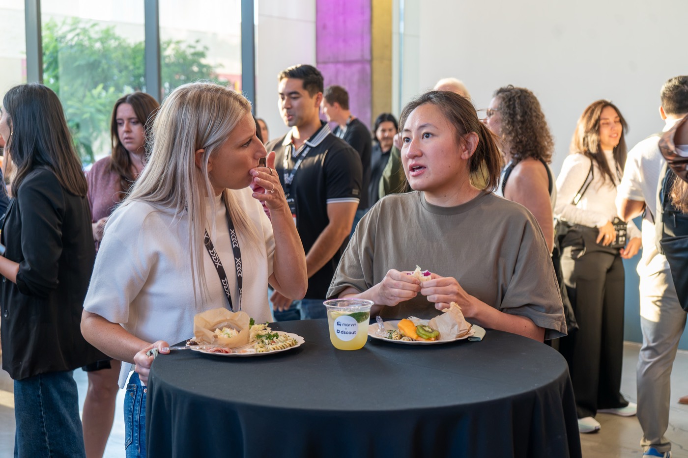 Attendees talking over food at the happy hour